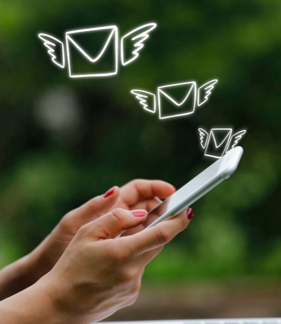 A girl sending emails from his mobile phone